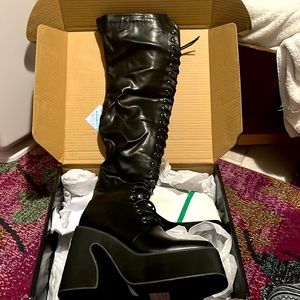 Brand new DollsKill thigh high black lace boots. Sexy thigh high maculate boots.